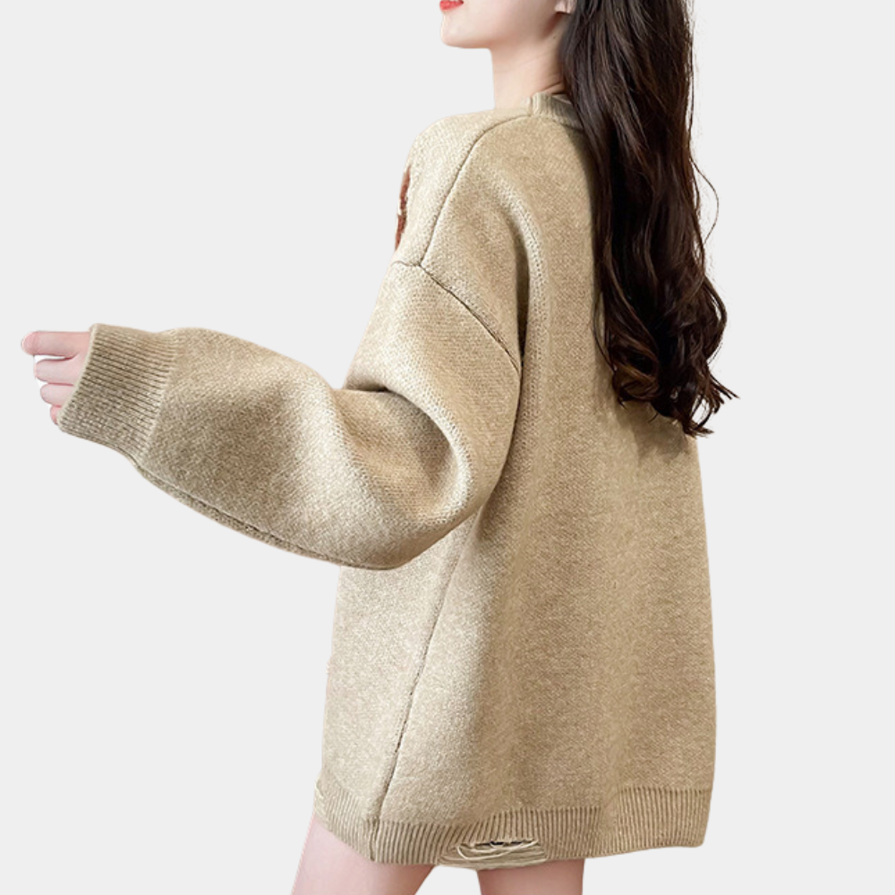 Vrouw in oversized beige trui met lange mouwen, casual mode, zijaanzicht. Perfect voor herfst- en winterstijl, comfortabele dameskleding.