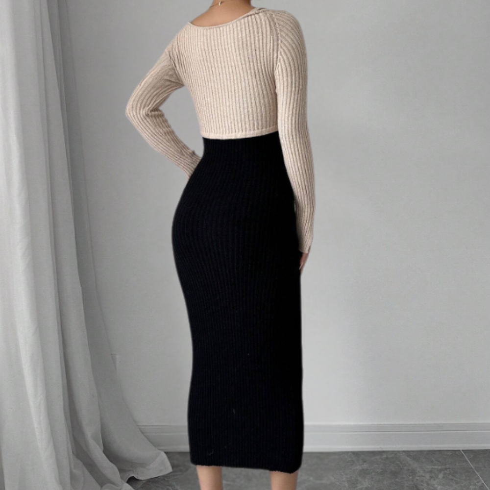 Vrouw in stijlvolle, tweekleurige gebreide jurk, beige top en zwarte rok, staand voor een witte achtergrond. Elegante mode, minimalistisch design.
