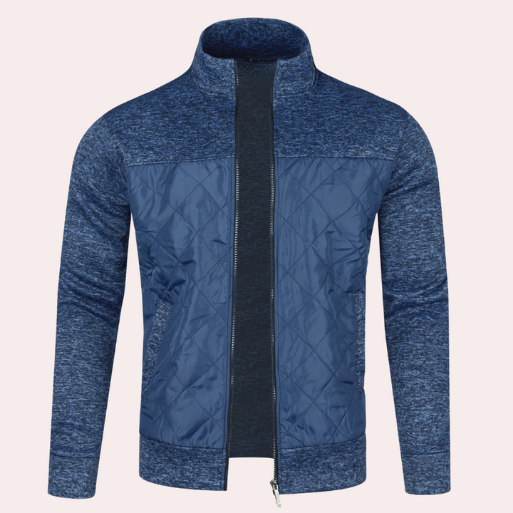 Blauwe herenjas met rits, gewatteerd ontwerp, hoge kraag en gemêleerde mouwen. Stijlvolle en warme jas voor casual en sportieve gelegenheden.