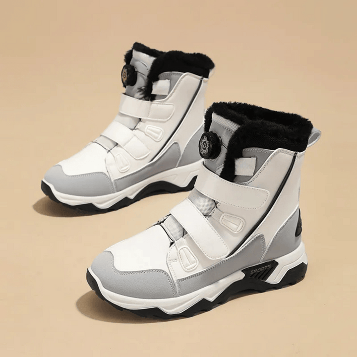 Witte en grijze winterlaarzen met klittenbandsluiting en zwarte bontvoering, ideaal voor koude weersomstandigheden. Comfortabele en stijlvolle snowboots.