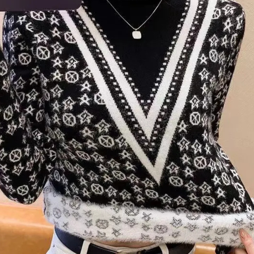 Zwart-witte trui met geometrisch patroon en V-hals, gedragen door persoon. Modieuze dameskleding, wintertrui, stijlvolle outfit.