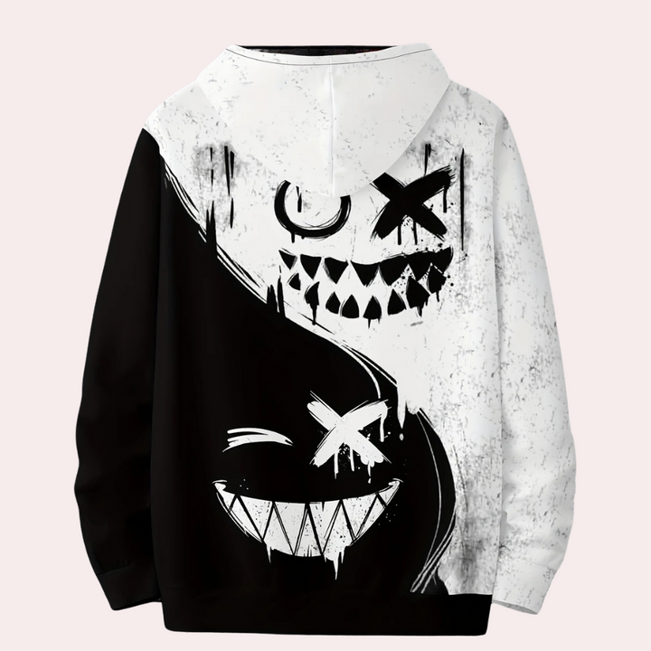 Zwart-witte hoodie met abstracte, grijnzende gezichten en yin-yang ontwerp. Streetwear mode, unisex, grafische print, casual stijl.