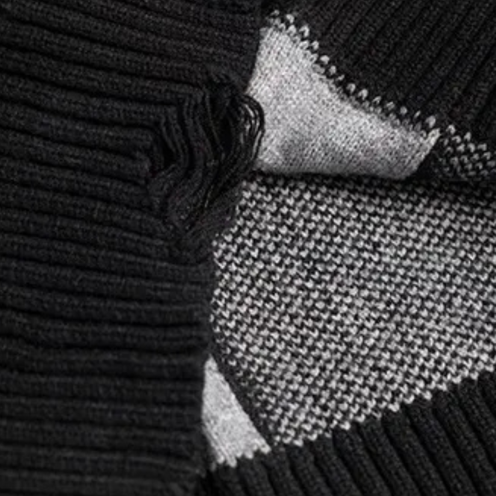 Zwart-wit gebreide sjaal met geribbelde textuur en geometrisch patroon, warme winteraccessoire, modieuze uniseks sjaal.