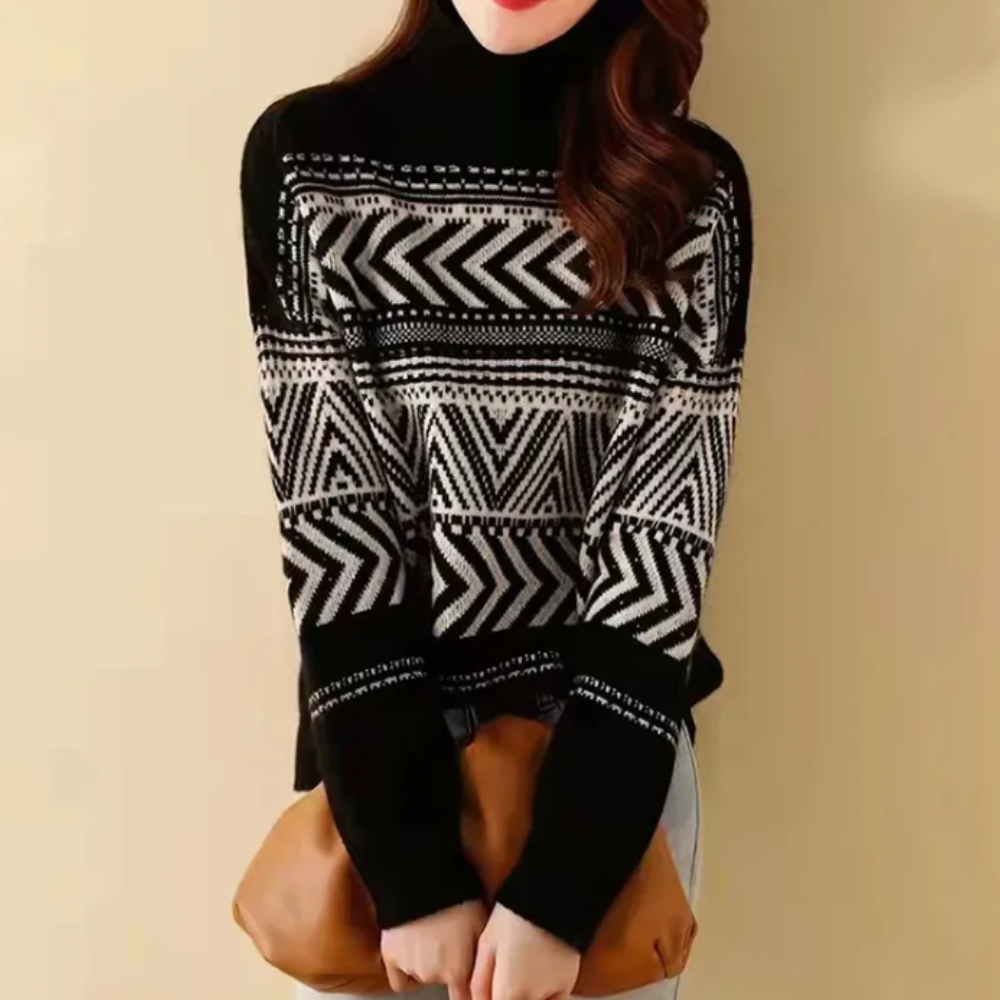 Vrouw draagt zwarte trui met geometrisch zigzagpatroon, gecombineerd met bruine tas. Modieuze winterkleding, trendy damesmode.