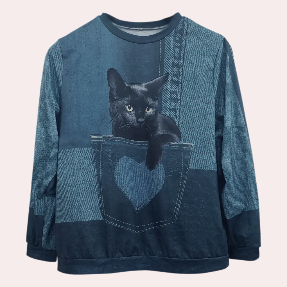 Blauwe trui met kattenprint, zwarte kat in zak met hartvormig detail, casual damesmode, comfortabele katoenen sweater, trendy kleding.