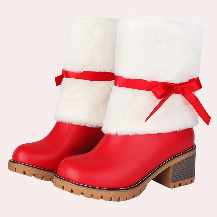 Rode dameslaarzen met witte bontkraag en rode strik, stevige hak en rubberen zool. Perfect voor wintermode en kerstoutfits.