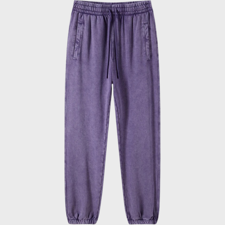 Donkerpaarse joggingbroek met elastische tailleband en trekkoord, zijzakken, comfortabele pasvorm. Perfect voor casual en sportieve looks.