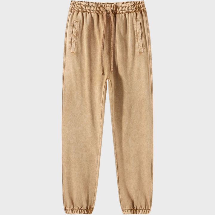 Beige joggingbroek met elastische tailleband en trekkoord, zijzakken, casual stijl, comfortabele pasvorm, unisex mode, trendy streetwear.