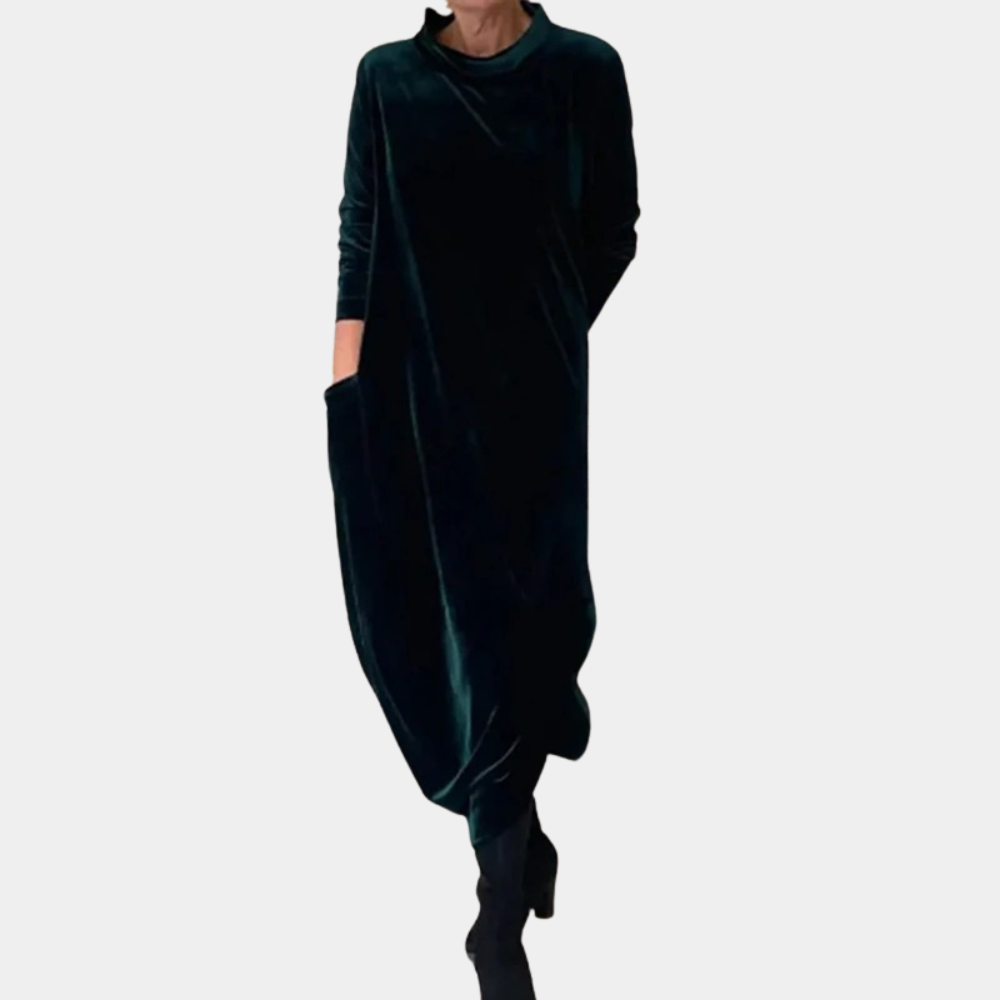 Donkergroene fluwelen maxi-jurk met lange mouwen en zakken, elegant en comfortabel, perfect voor herfst- en wintermode.