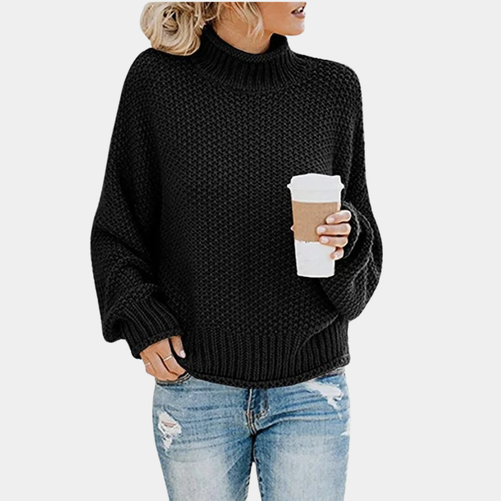 Vrouw in zwarte gebreide trui met col, houdt een koffiebeker vast. Casual herfstmode, trendy dameskleding, comfortabele outfit.