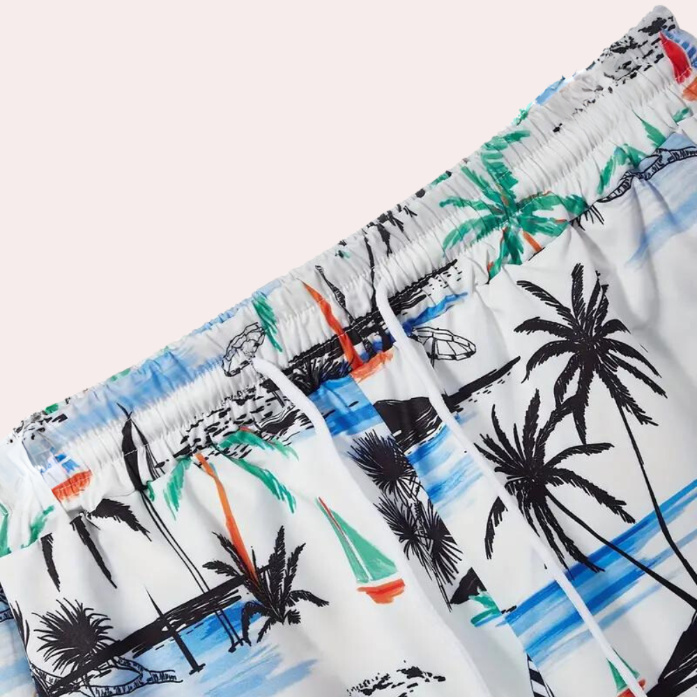 Kleurrijke zwembroek met tropische print, palmbomen en zeilboten. Perfect voor strandvakanties en zomerse activiteiten. Comfortabele elastische taille.