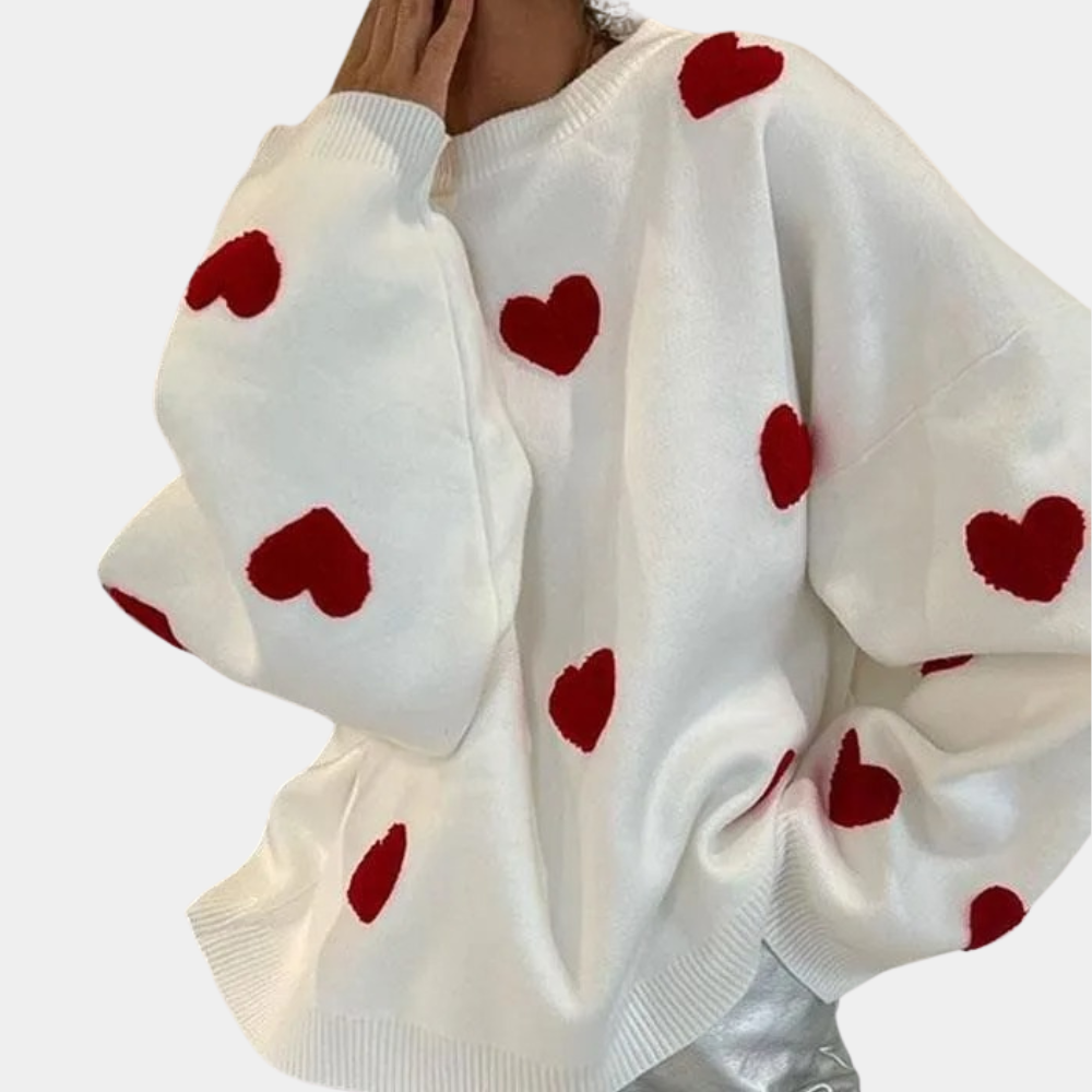 Witte trui met rode hartjes, oversized pasvorm, trendy damesmode, comfortabele sweater, casual stijl, perfect voor herfst en winter.