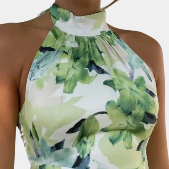 Groene halterjurk met bloemenprint, mouwloos ontwerp, elegante en zomerse stijl, perfect voor casual en formele gelegenheden.