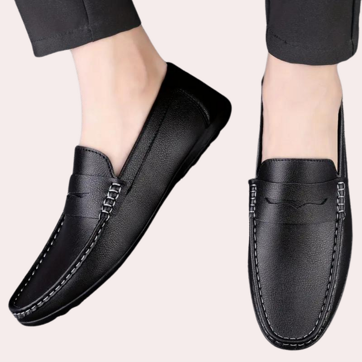 Zwarte leren loafers voor heren, stijlvolle instappers met stiksels, geschikt voor casual en formele gelegenheden. Comfortabele herenschoenen.