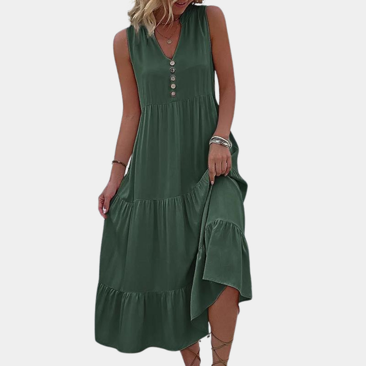 Groene maxi-jurk met knoopsluiting, mouwloos ontwerp en vloeiende rok. Perfect voor zomerse gelegenheden. Trendy damesmode.