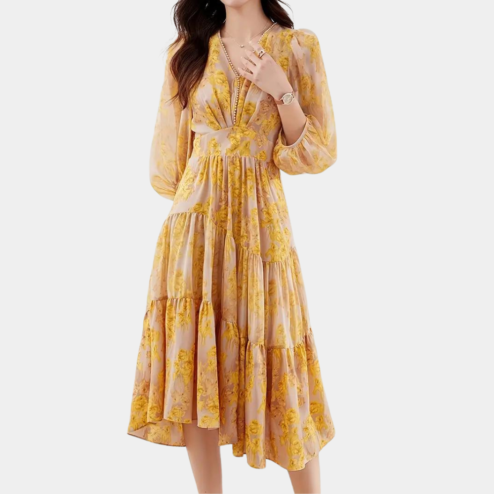 Vrouw in gele bloemenjurk met lange mouwen, V-hals en geplooide rok. Modieuze dameskleding, ideaal voor lente- en zomerseizoenen.