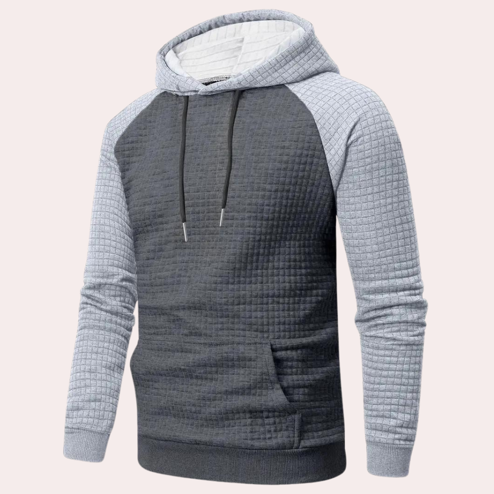 Grijze gewatteerde hoodie met capuchon en trekkoorden, lange mouwen en buidelzak. Comfortabele herentrui, ideaal voor casual en sportieve looks.