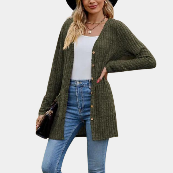 Vrouw in groene ribgebreide cardigan met knopen, witte top en blauwe jeans. Stijlvolle herfstmode, casual outfit, trendy dameskleding.