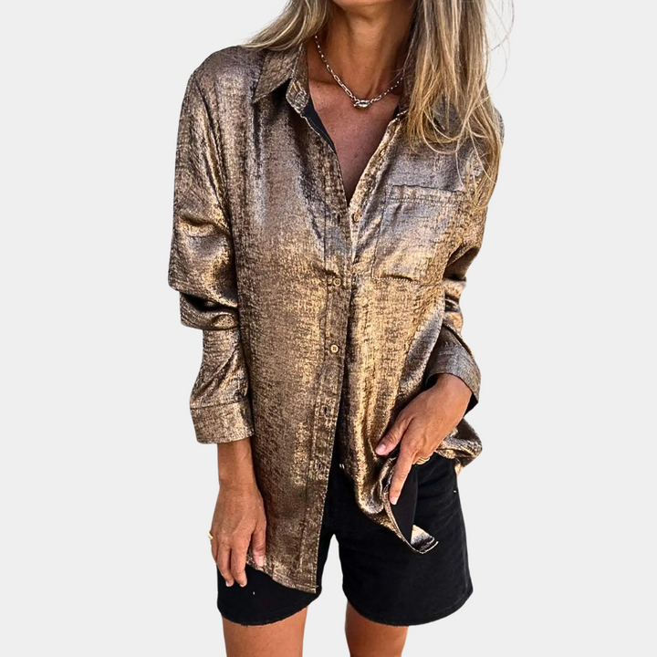 Gouden metallic blouse voor dames, lange mouwen, casual stijl, perfect voor feestjes en avondjes uit. Glanzende stof, modieuze uitstraling.
