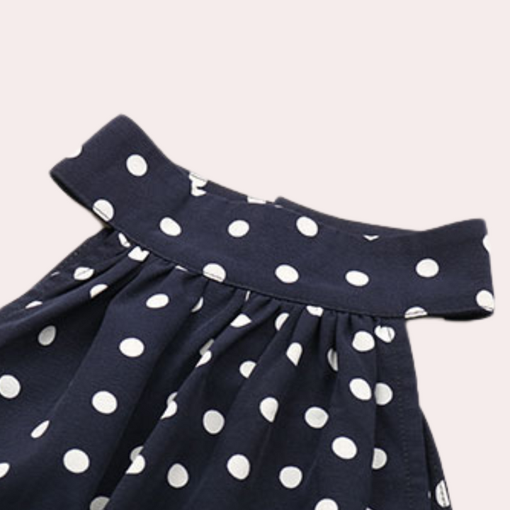 Donkerblauwe rok met witte stippen, hoge tailleband, vintage stijl. Perfect voor damesmode, retro look, elegante kleding.