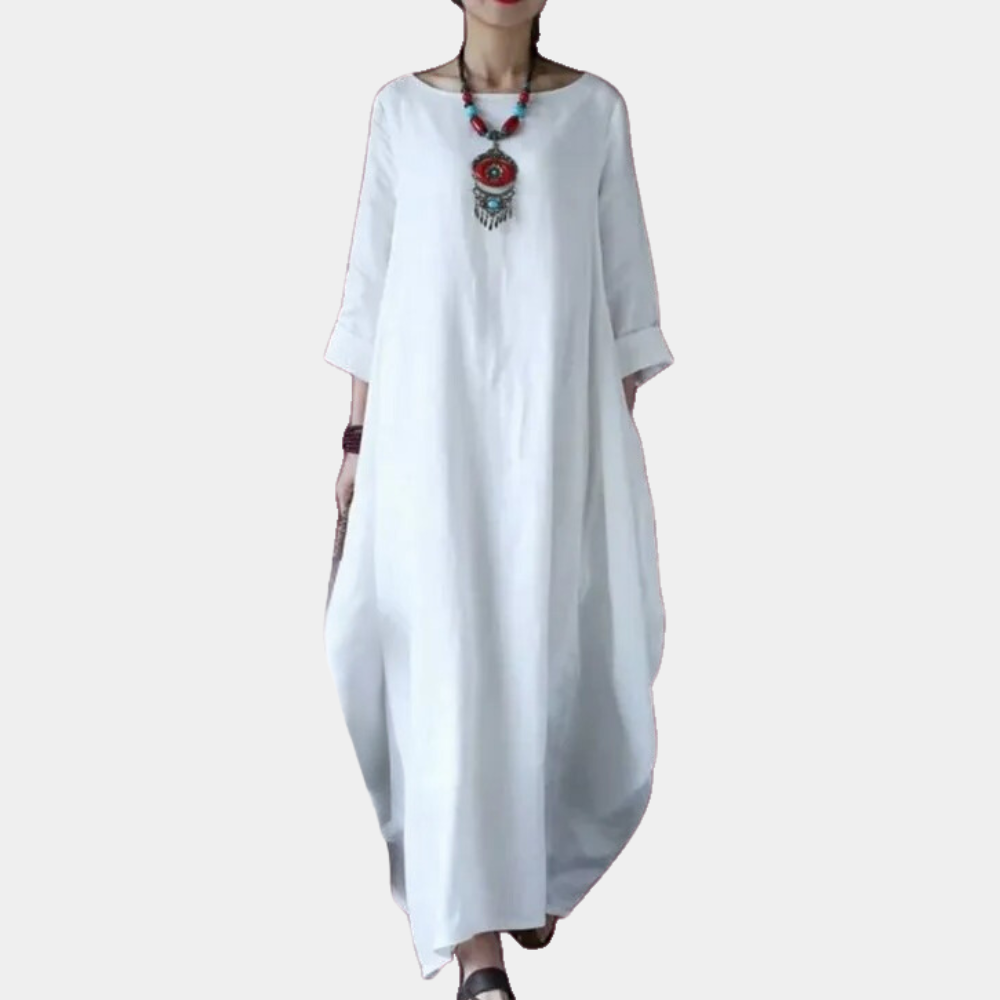 Witte maxi-jurk met lange mouwen, losse pasvorm en ronde hals. Stijlvolle damesmode, ideaal voor casual en zomerse gelegenheden.