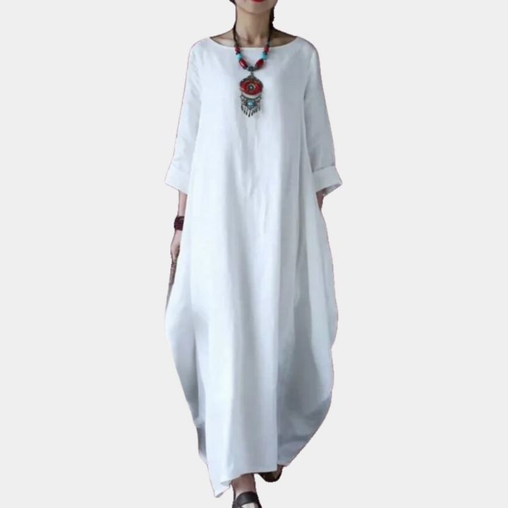 Witte maxi-jurk met lange mouwen, losse pasvorm en ronde hals. Stijlvolle damesmode, ideaal voor casual en zomerse gelegenheden.
