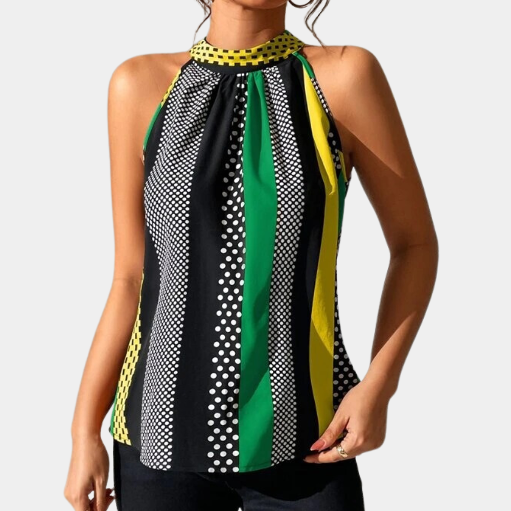 Vrouw draagt mouwloze top met halternek, gestreept patroon in zwart, wit, groen en geel. Modieuze dameskleding, zomerse stijl, polkadot details.