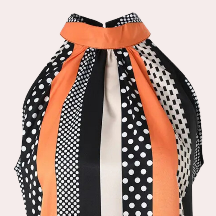 Oranje en zwart gestreepte en gestippelde haltertop, retro stijl, damesmode, elegante blouse, opvallend patroon, trendy kleding.