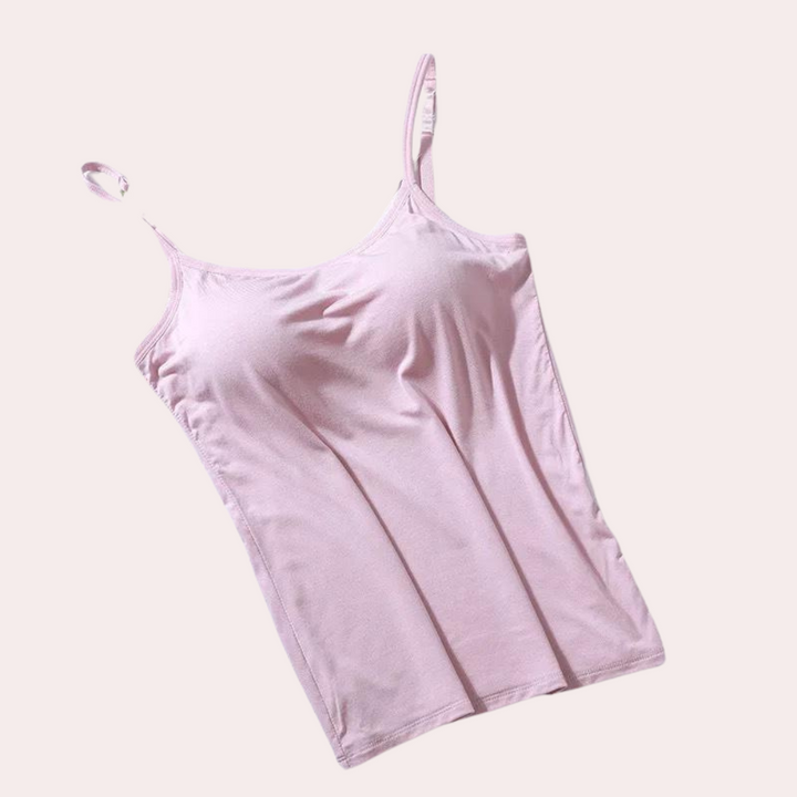 Roze dameshemdje met spaghettibandjes, gemaakt van zachte stof. Perfect voor casual outfits en zomerse dagen. Comfortabel en stijlvol ontwerp.
