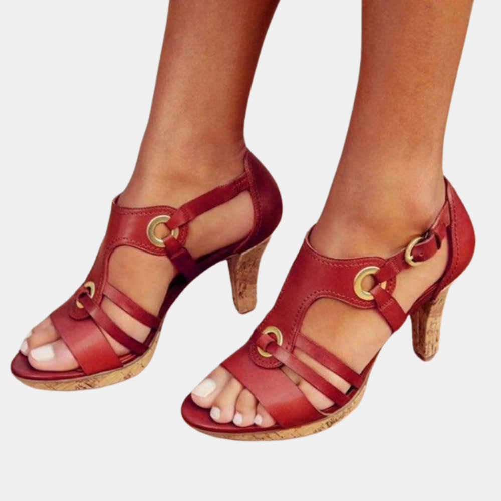 Rode leren sandalen met hoge hakken en kurkzool, open teen en gouden gespen. Stijlvolle damesmode, perfect voor zomerse outfits.