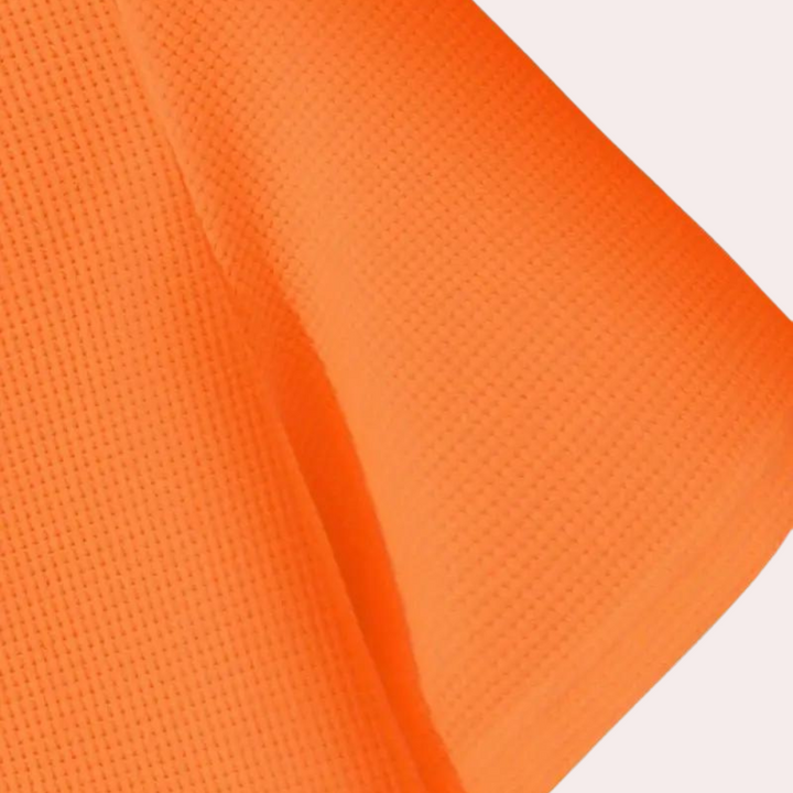Oranje stof met textuur, close-up. Ideaal voor modeontwerp, interieurdecoratie. Hoogwaardige textiel, levendige kleur, veelzijdig gebruik.