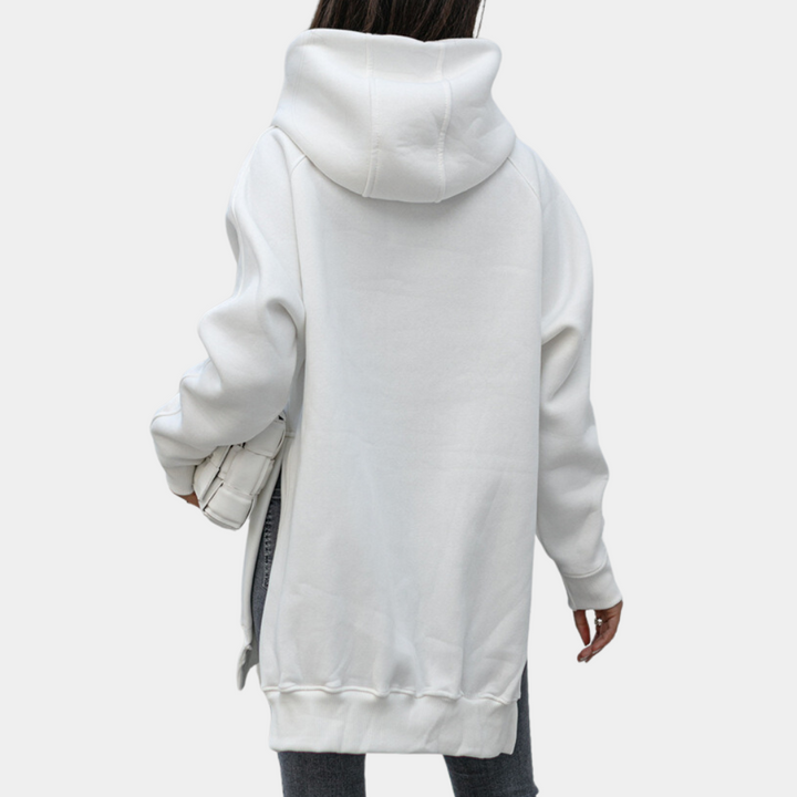 Witte oversized hoodie met capuchon, gedragen door persoon van achteren. Comfortabele streetwear, ideaal voor casual mode en herfstkleding.