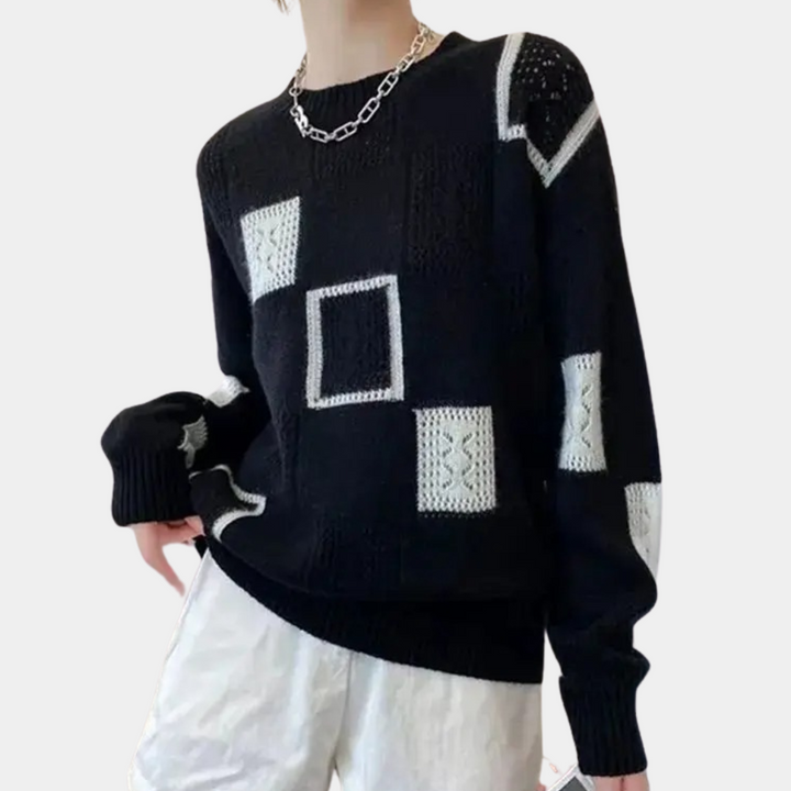 Zwarte trui met witte geometrische patronen, lange mouwen en ronde hals. Modieuze dameskleding, perfect voor casual en stijlvolle outfits.