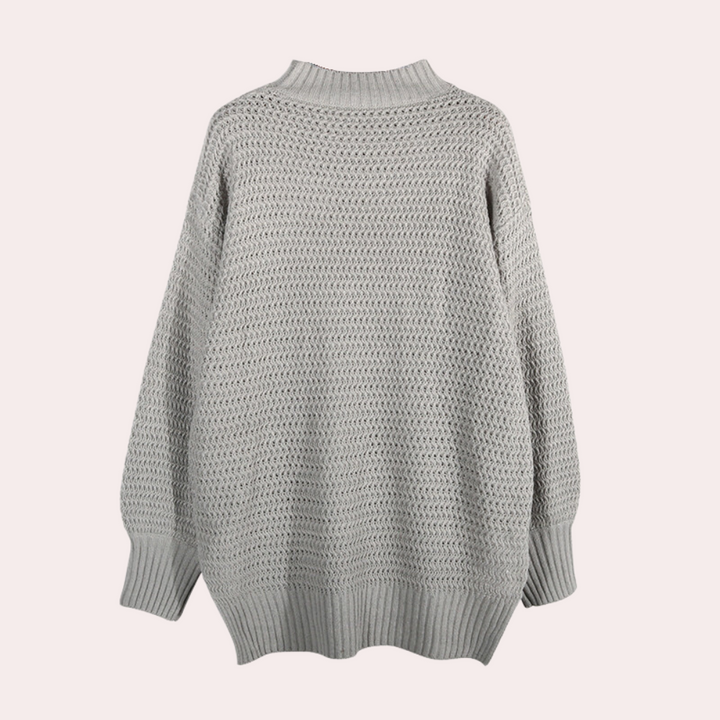 Grijze gebreide trui met hoge kraag, lange mouwen en textuurpatroon. Perfect voor herfst- en wintermode. Comfortabel en stijlvol ontwerp.