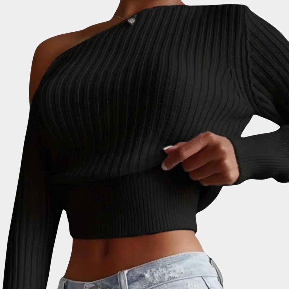 Zwarte asymmetrische trui met één schouder, geribbelde stof, gedragen door model. Trendy damesmode, casual stijl, perfect voor herfst en winter.