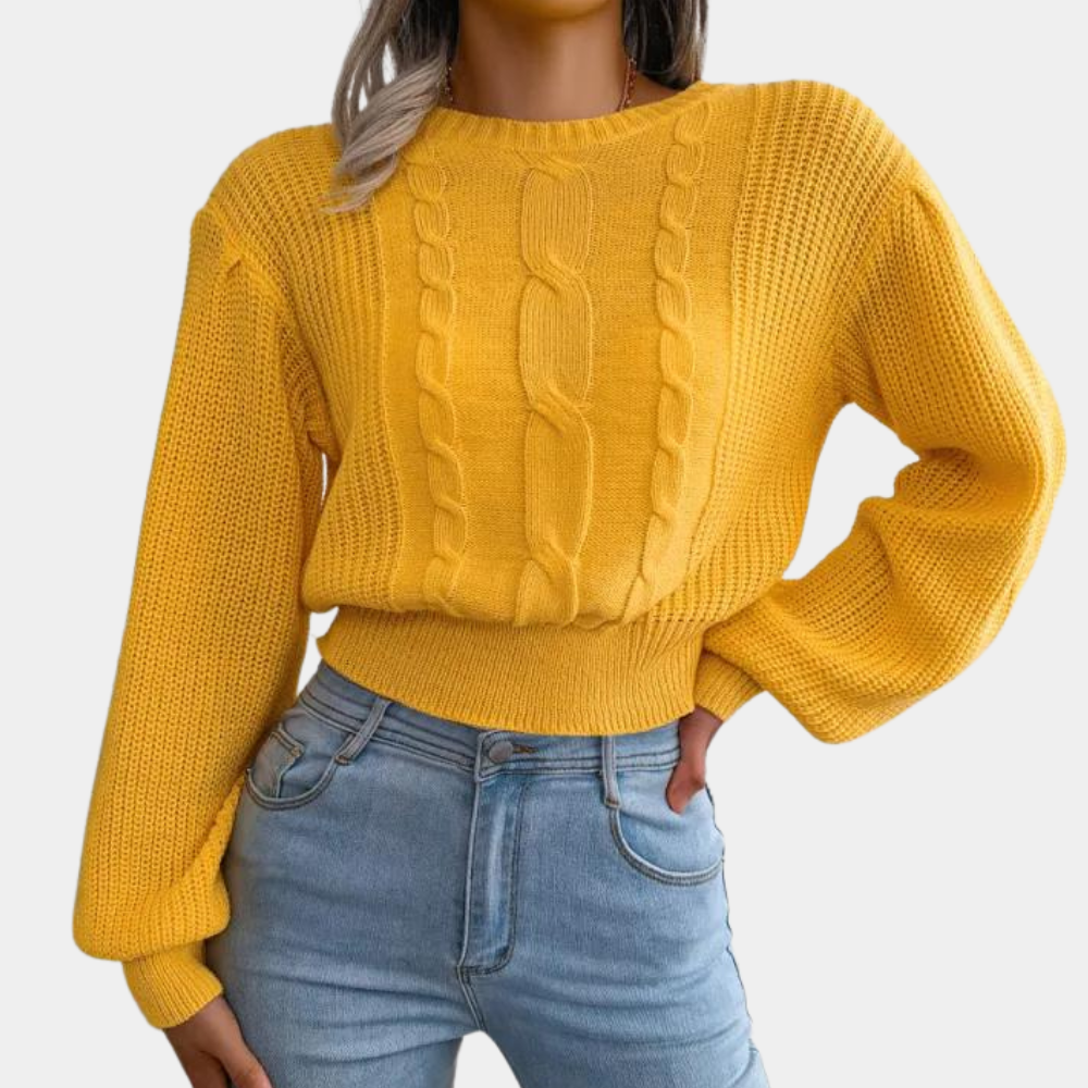 Vrouw in gele kabeltrui met lange mouwen en blauwe jeans. Modieuze dameskleding, herfstoutfit, casual stijl.