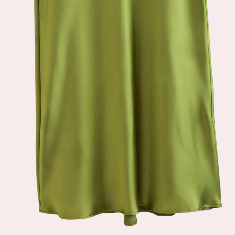 Groene satijnen rok, vloeiende stof, elegante uitstraling, modieuze dameskleding, perfect voor lente- en zomeroutfits, stijlvolle modekeuze.
