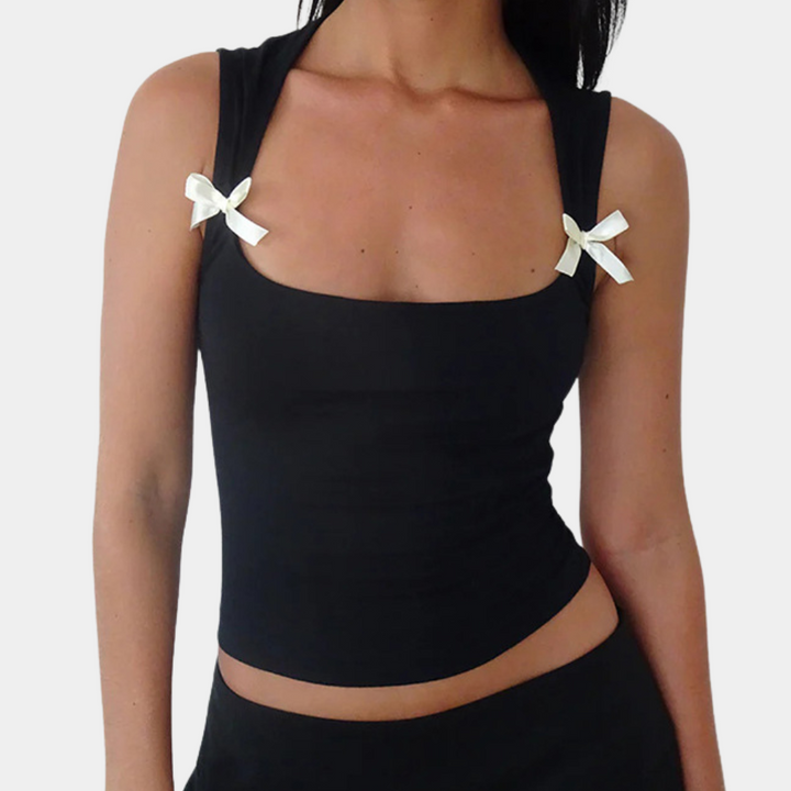 Zwarte dames tanktop met vierkante halslijn en witte strikjes op de schouders. Stijlvolle en trendy top voor casual en elegante outfits.