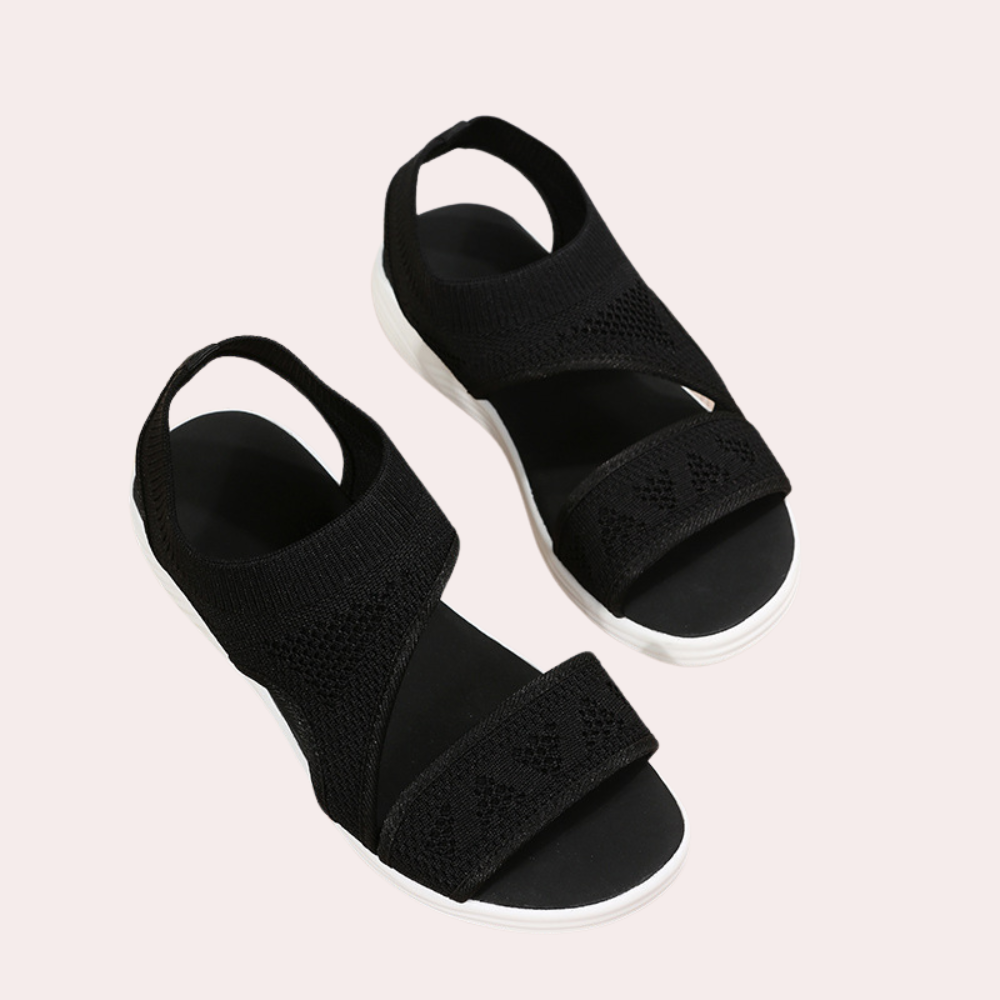 Zwarte dames sandalen met elastische band, open teen en witte zool. Comfortabele zomerschoenen, ideaal voor casual en trendy outfits.