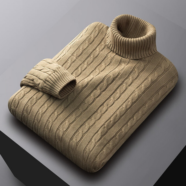 Lichtbruine kabeltrui met col, opgevouwen op een grijze achtergrond. Stijlvolle herentrui, warme wintermode, gebreide kleding.