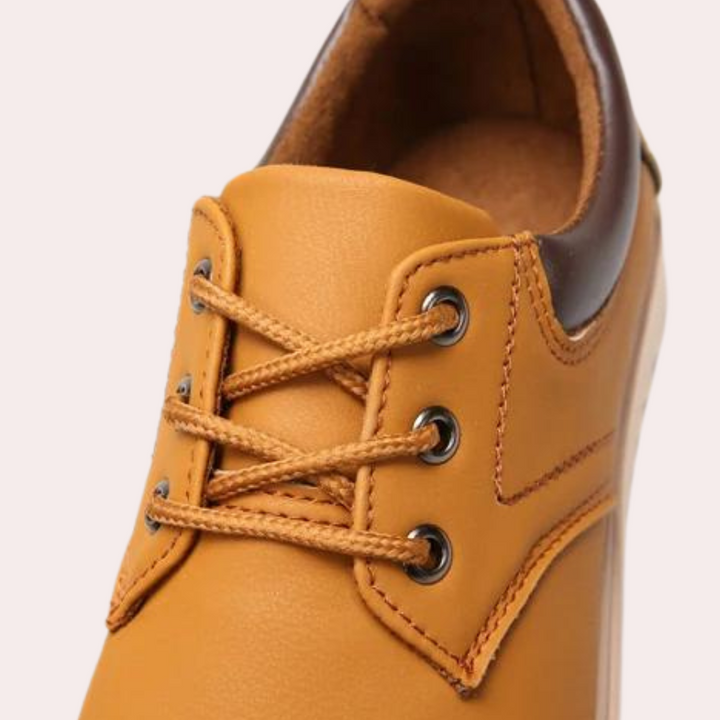 Bruine leren herenschoen met veters, metalen oogjes en gestikte details. Stijlvolle casual schoen voor dagelijks gebruik.