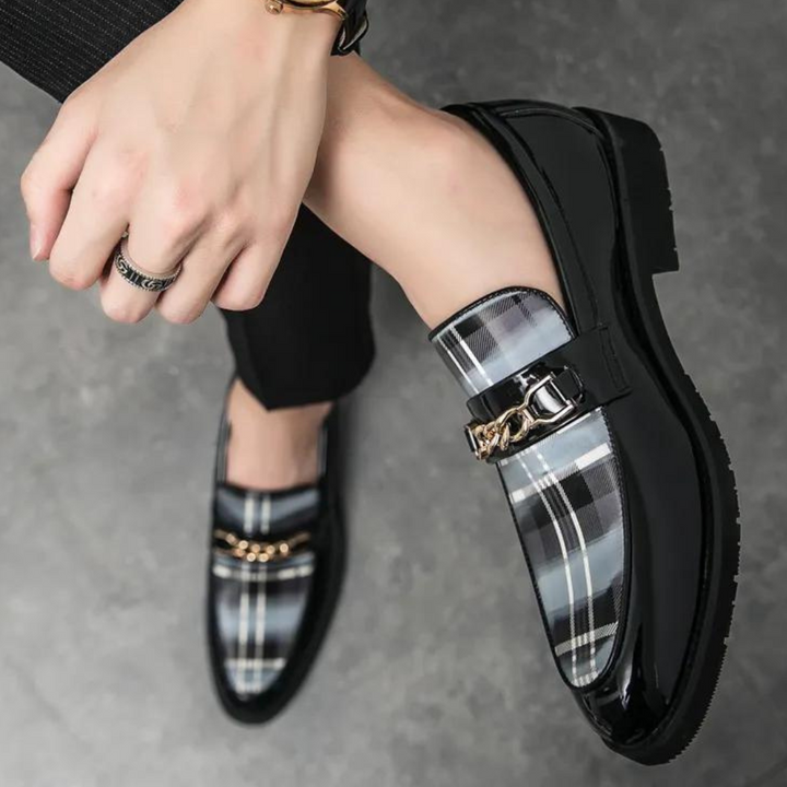 Zwart gelakte herenschoen met geruit patroon en metalen gesp, stijlvolle leren loafers voor heren, modieuze formele schoenen, elegant design.