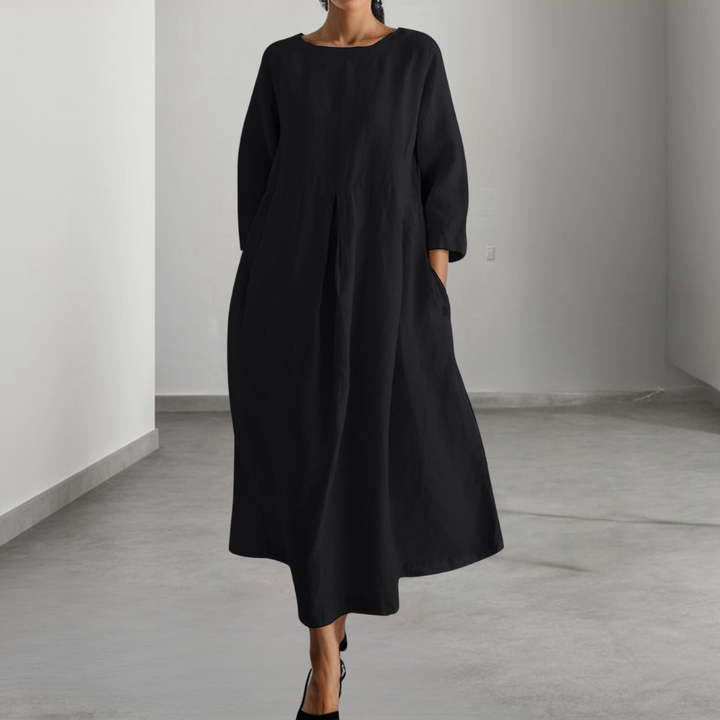 Zwarte midi-jurk met lange mouwen, minimalistisch design, comfortabele pasvorm, geschikt voor casual en formele gelegenheden, damesmode.
