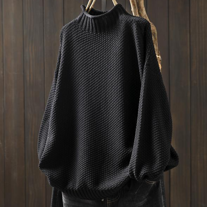 Zwarte gebreide trui met hoge kraag, losse pasvorm en textuur, perfect voor herfst- en wintermode. Comfortabele dameskleding, stijlvolle sweater.