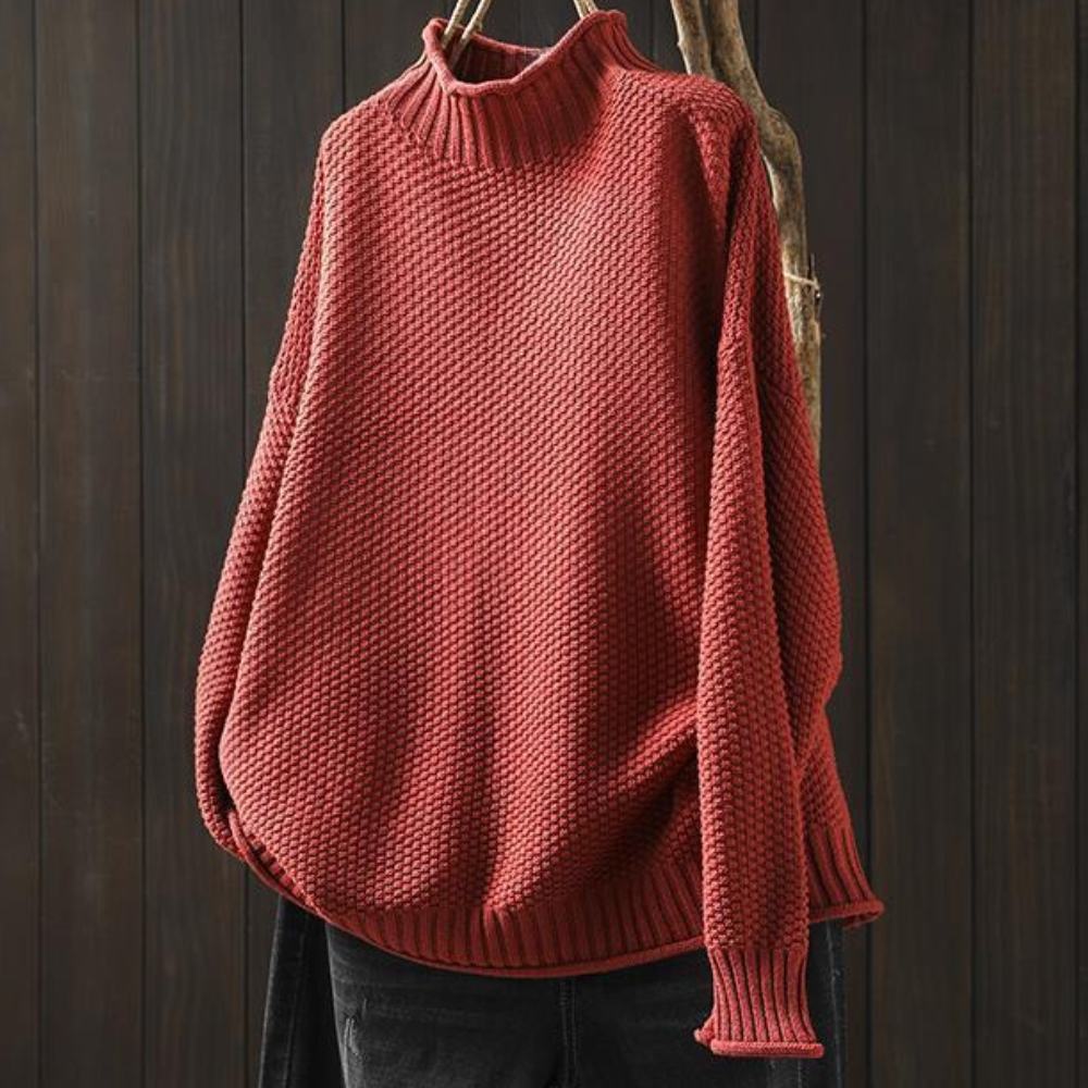 Rode gebreide trui met col, losse pasvorm, hangend op houten achtergrond. Perfect voor herfstmode, warme kleding, damestrui.