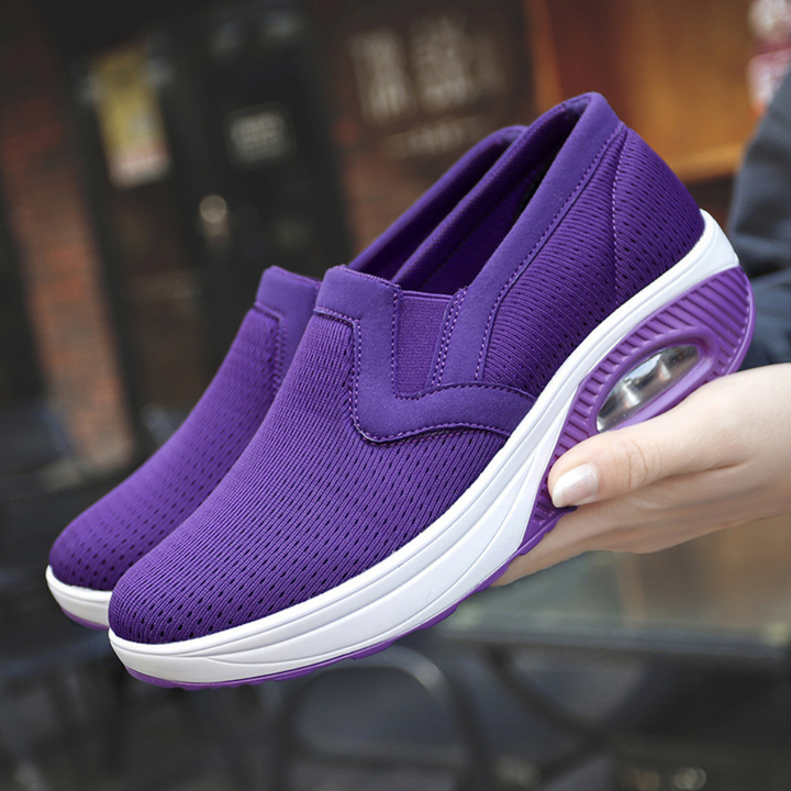 Paarse dames sneakers met ademend mesh, verhoogde zool en slip-on design. Comfortabele sportschoenen voor dagelijks gebruik.