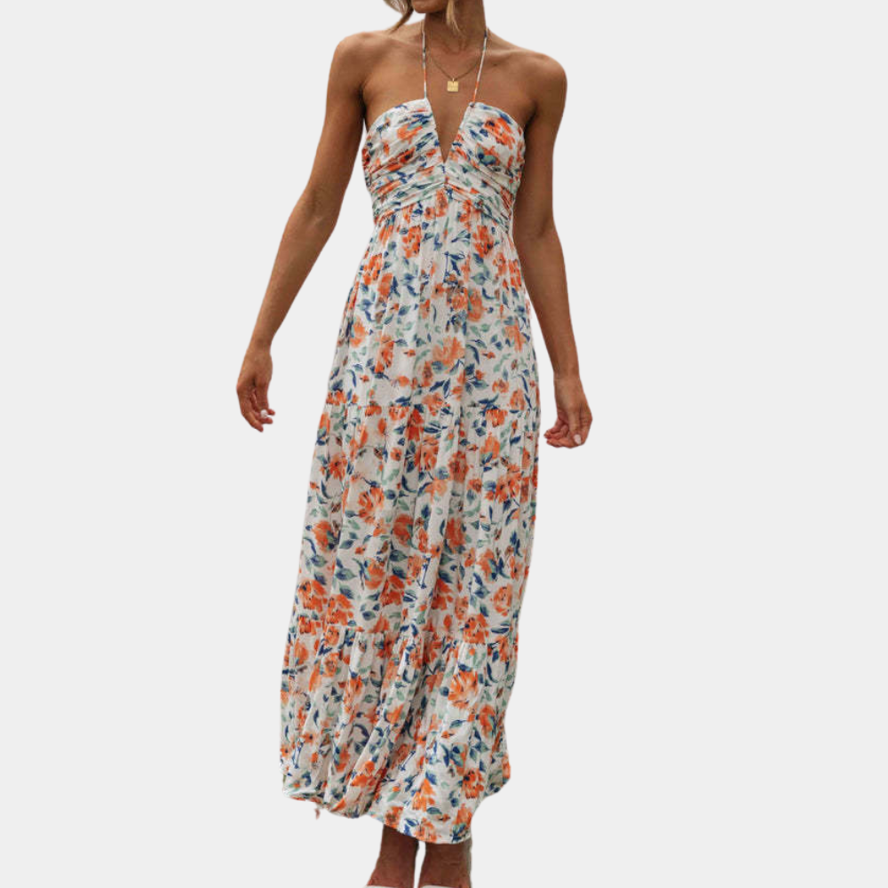 Oranje bloemenjurk met strapless ontwerp, vloeiende pasvorm en zomerse print. Perfect voor casual en elegante gelegenheden. Trendy damesmode.