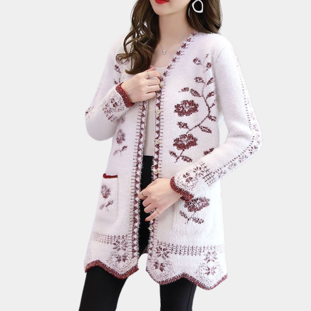 Witte gebreide damesvest met rode bloemenprint, lange mouwen en zakken. Stijlvolle en warme cardigan voor herfst- en wintermode.