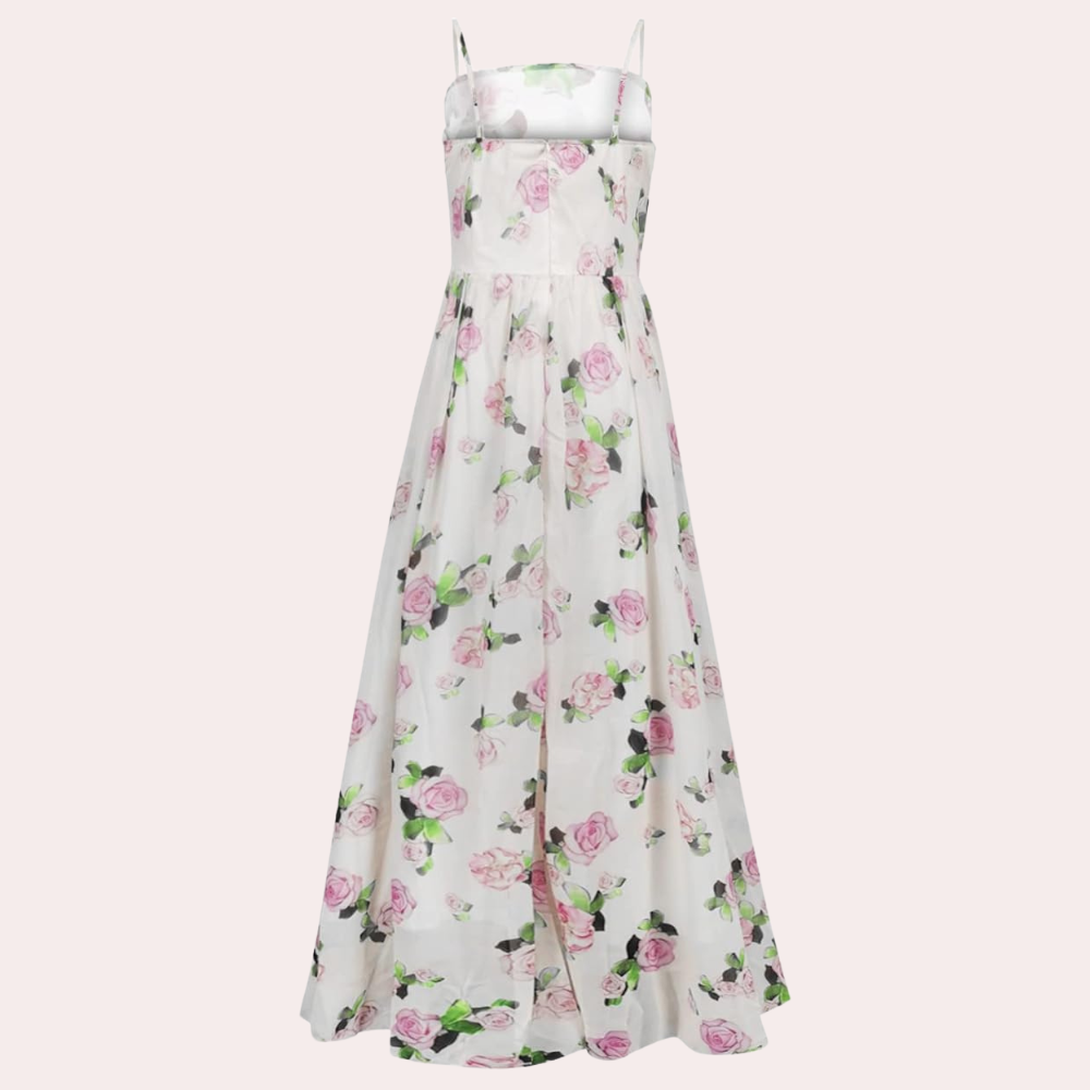 Witte maxi-jurk met roze bloemenprint, spaghetti bandjes en vloeiende rok. Perfect voor zomerse evenementen en bruiloften. Elegante damesmode.