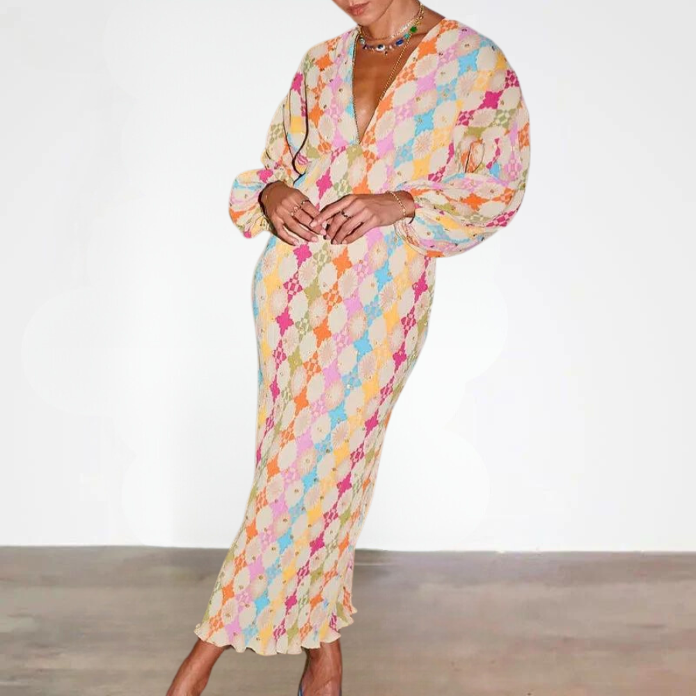 Vrouw in kleurrijke, lange jurk met ruitpatroon en pofmouwen, modetrend 2023, elegante dameskleding, stijlvolle outfit voor speciale gelegenheden.